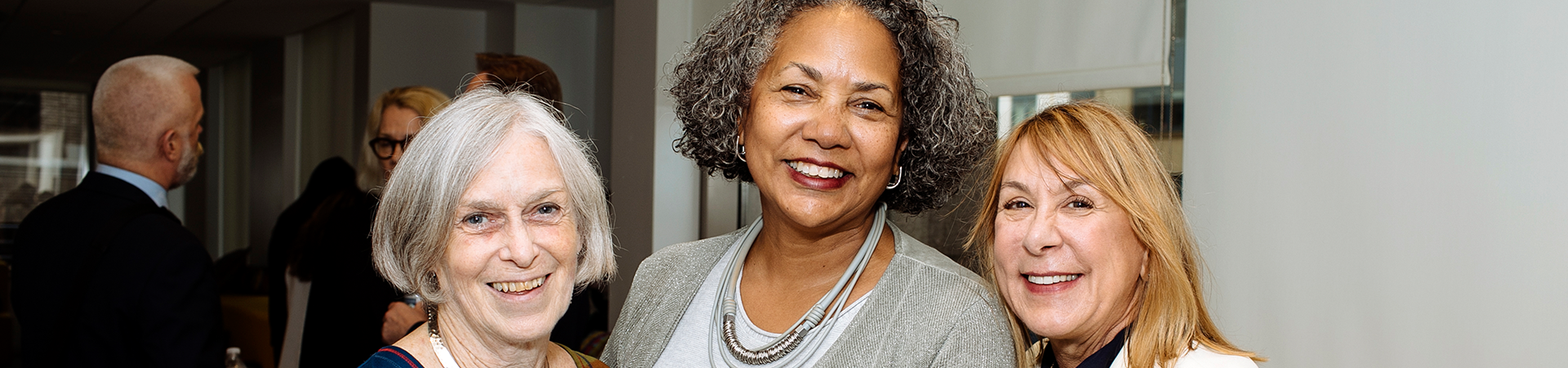  girl scout alum adult women retirement age smiling at camera 